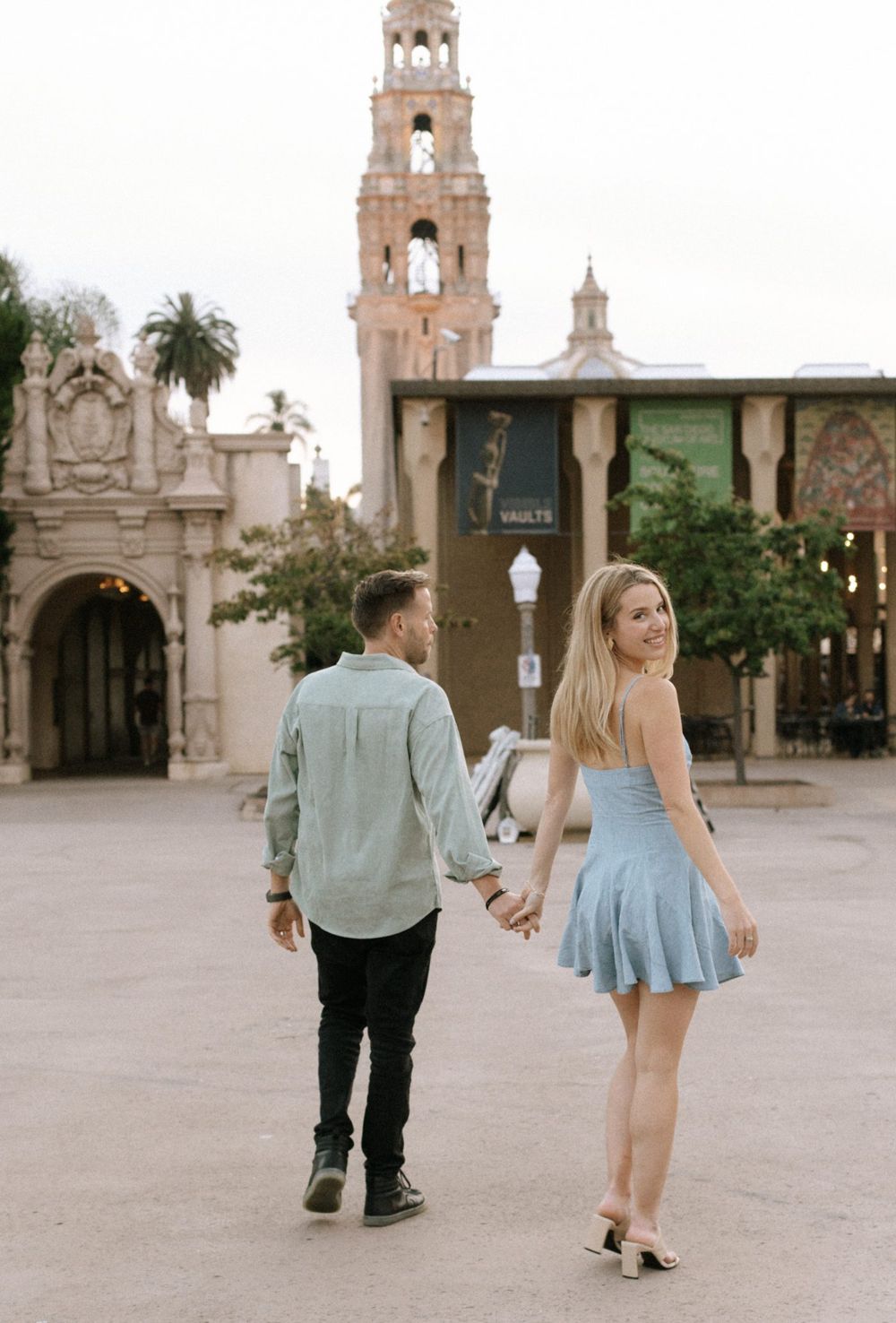 Annie and Serik walking hand in hand in Balboa Park