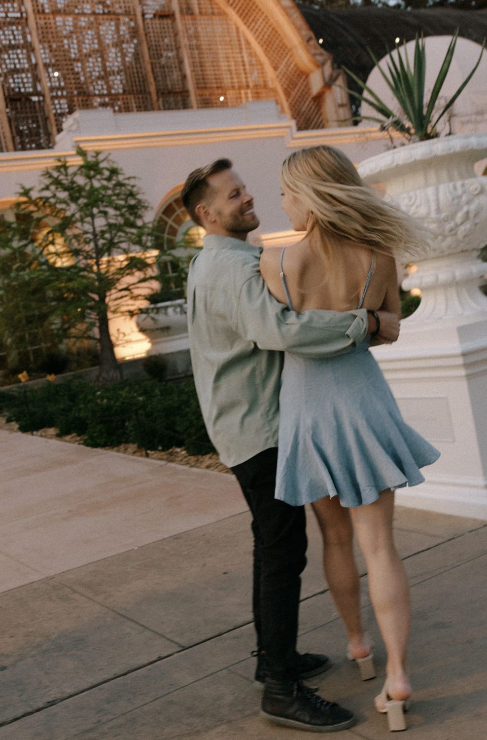 Annie and Serik embracing at sunset